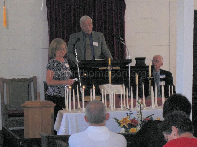 reubinthompson_org_20.jpg - Lighting memorial candles in remembrance of those cousins who had passed away during the past year; Philip Stephens at the podium, Martha Walker lighting memorial candles.